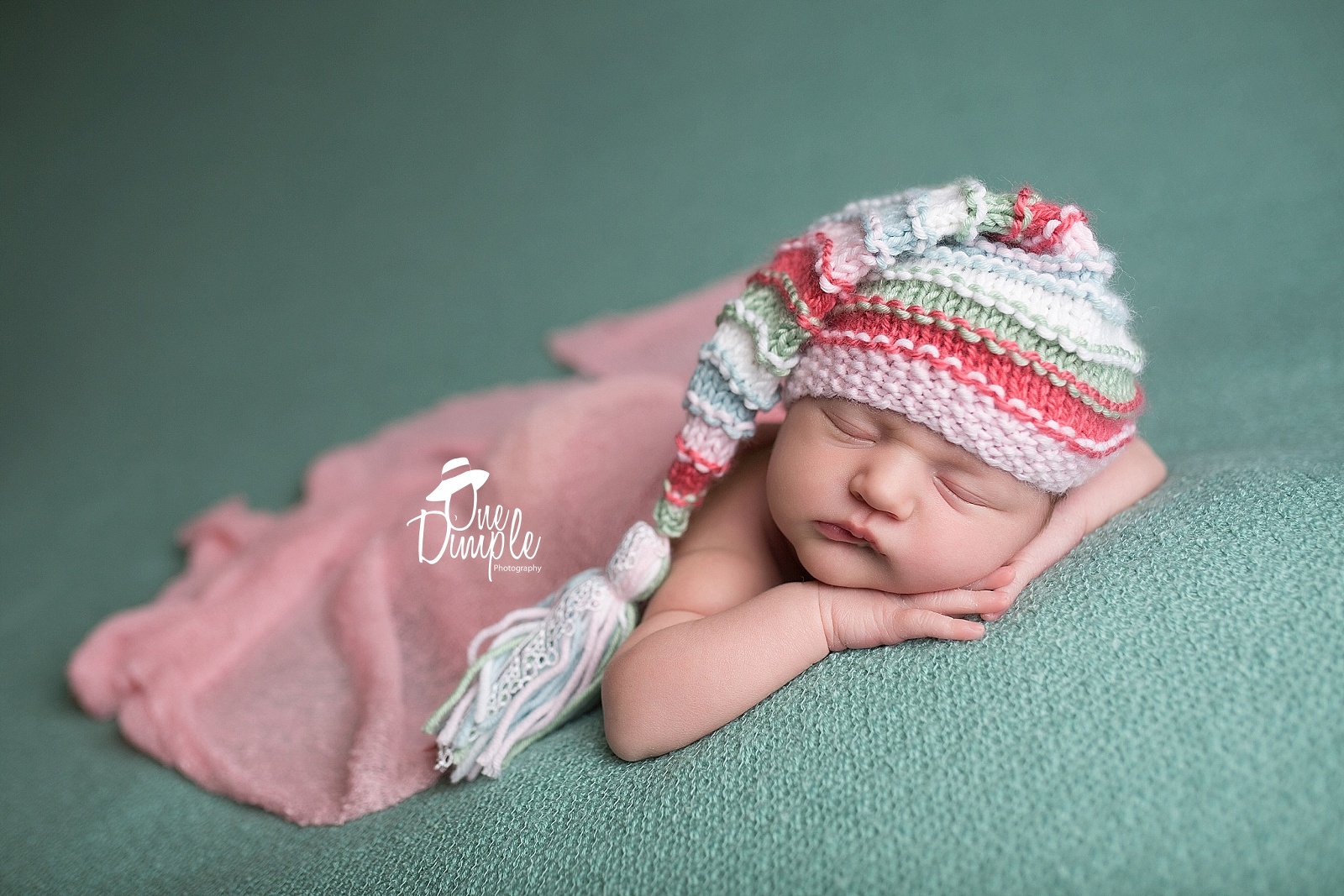 newborn with stripped elf hat