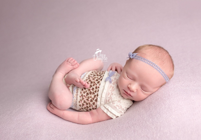 In-home newborn session with baby in lace outfit