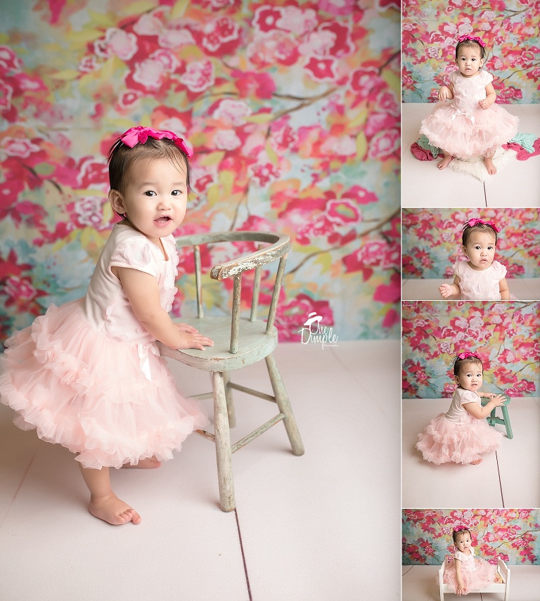 Floral backdrop with little girl celebrating 1st birthday