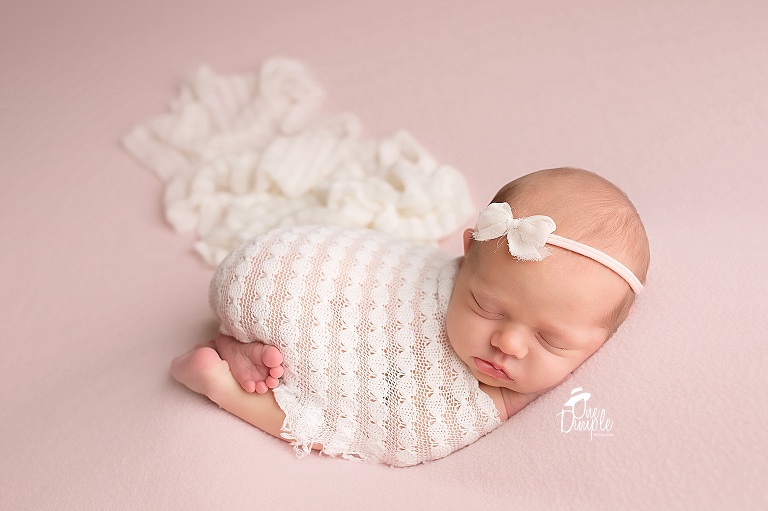 Tushie Up Posed Newborn on Pink and Cream