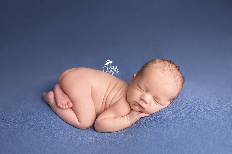One Dimple Photography DFW In-Home Newborn Photographer Newborn back laying posing with pouty lip
