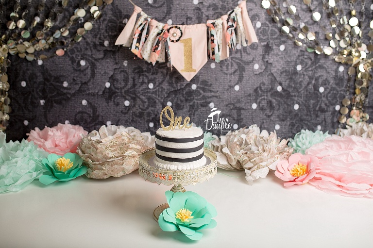 One Dimple Photography Specializies in custom 1 year cake smash sessions.  This session was a custom black and floral cake smash session. 
