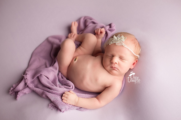 One Dimple Photography is a Dallas Fort Worth newborn and baby photographer.  In-home Newborn Session in Fort Worth Texas wrapped baby in back laying pose. 