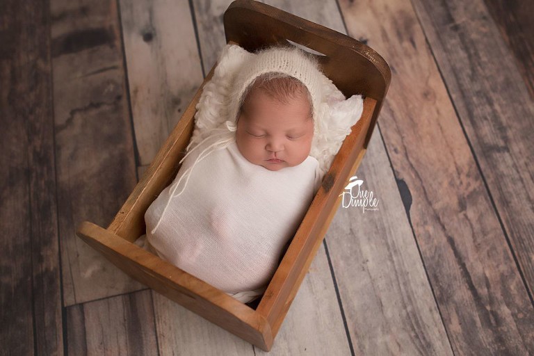 Dallas Newborn Photographer baby in crate bed